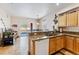 A well-lit kitchen with wood cabinets, granite countertops, and sliding door to a winter view at 57 Audrey Cir, Breckenridge, CO 80424