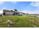 Spacious backyard with a walkout deck, overlooking the large lawn and white fencing of the property at 1788 Shoshone Trl, Elizabeth, CO 80107