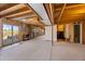 Unfinished basement leading to the backyard through sliding glass doors, adjacent to laundry and bathroom at 1788 Shoshone Trl, Elizabeth, CO 80107