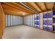 Unfinished basement featuring exposed beams, insulated walls, and concrete flooring at 1788 Shoshone Trl, Elizabeth, CO 80107