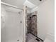 Bathroom with a white shower, toilet, and stone accents at 1788 Shoshone Trl, Elizabeth, CO 80107