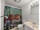 Bathroom features single vanity and decorative shower curtain at 1788 Shoshone Trl, Elizabeth, CO 80107