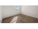 A carpeted bedroom features a large window for natural light at 1788 Shoshone Trl, Elizabeth, CO 80107