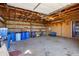 Spacious garage with exposed beam ceiling and ample storage space for tools and equipment at 1788 Shoshone Trl, Elizabeth, CO 80107