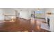 Bright living room featuring wood floors, fireplace, ceiling fan, and access to a deck at 1788 Shoshone Trl, Elizabeth, CO 80107