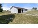 An outbuilding with a garage door is situated on a grassy field under a blue sky at 1788 Shoshone Trl, Elizabeth, CO 80107