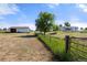 A farm or ranch landscape features an outbuilding and fenced pasture under a blue sky at 1788 Shoshone Trl, Elizabeth, CO 80107