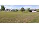 Property featuring a house, outbuilding, and trailer, set in a large, grassy yard on a sunny day at 1788 Shoshone Trl, Elizabeth, CO 80107