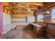 Bright workshop space with natural light, workbench, storage shelves, and exterior view at 1788 Shoshone Trl, Elizabeth, CO 80107