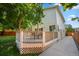 Side view of a backyard deck, a large tree, and an outside stairway with a sidewalk at 19118 E Grand Cir, Aurora, CO 80015