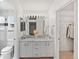 Bright bathroom with dual sinks, a walk-in closet, and a separate toilet room at 19118 E Grand Cir, Aurora, CO 80015