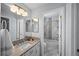 Bright bathroom featuring a modern vanity, stylish mirror and combination shower and bathtub at 19118 E Grand Cir, Aurora, CO 80015