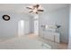 Spacious bedroom with a vaulted ceiling, ceiling fan, dresser, and neutral decor at 19118 E Grand Cir, Aurora, CO 80015