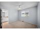 Bedroom featuring a ceiling fan, window, and view into the attached bathroom at 19118 E Grand Cir, Aurora, CO 80015