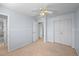 Bedroom featuring a ceiling fan, neutral carpet, access to the bathroom, and closet at 19118 E Grand Cir, Aurora, CO 80015