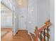 Inviting entryway with hardwood floors, staircase, and natural light streaming through the decorative front door window at 19118 E Grand Cir, Aurora, CO 80015