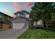 Charming two-story home features a well-manicured lawn, brick accents, and an attached two-car garage at 19118 E Grand Cir, Aurora, CO 80015