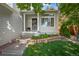 Charming front yard with a well-manicured lawn, landscaping, brick planter and covered porch at 19118 E Grand Cir, Aurora, CO 80015