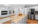 Spacious kitchen with a central island featuring a granite countertop, stainless steel appliances, and abundant storage at 19118 E Grand Cir, Aurora, CO 80015