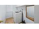Bright laundry room with a modern washing machine, tiled floor, and window at 19118 E Grand Cir, Aurora, CO 80015