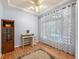 Comfortable office with hardwood floors, a decorative ceiling fan, and a built-in bookcase for storage at 19118 E Grand Cir, Aurora, CO 80015