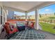 Relaxing covered deck with stylish outdoor furniture and a view of the expansive backyard at 6174 Flattop St, Golden, CO 80403
