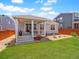 Well-kept backyard with covered porch, lawn, and landscaping that enhances outdoor appeal at 6174 Flattop St, Golden, CO 80403