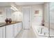 Bright bathroom featuring double sinks, white cabinets, soaking tub and natural light at 6174 Flattop St, Golden, CO 80403
