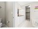 Bright bathroom featuring double sinks, white cabinets, and a soaking tub at 6174 Flattop St, Golden, CO 80403