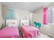 Bedroom with two twin beds and fun pink accents and decor at 6174 Flattop St, Golden, CO 80403