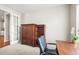 Bedroom with dark wood armoire, natural light and neutral paint at 6174 Flattop St, Golden, CO 80403