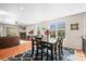 Well-lit dining room area with views to the living room fireplace and a large window at 6174 Flattop St, Golden, CO 80403