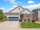 Charming single-Gathering home with a two-car garage, stone accents, and a well-manicured lawn at 6174 Flattop St, Golden, CO 80403