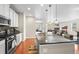 Open kitchen with a large island, stainless steel appliances, and hardwood floors at 6174 Flattop St, Golden, CO 80403
