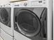 Modern laundry room with front-load washer and dryer units for convenient clothes washing at 6174 Flattop St, Golden, CO 80403