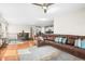 Open-concept living room and dining area featuring hardwood floors and a comfortable leather sofa at 6174 Flattop St, Golden, CO 80403