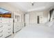 Bright main bedroom featuring white dressers, TV, and an ensuite bathroom at 6174 Flattop St, Golden, CO 80403