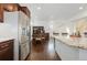 Kitchen with stainless steel refrigerator and granite island at 5480 Danube St, Denver, CO 80249