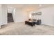 Spacious finished basement featuring plush carpeting, a cozy sofa, and stairway access to the upper level at 21855 E Idyllwilde Dr, Parker, CO 80138