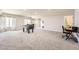 Bright basement featuring large windows, plush carpeting, and a foosball table for entertainment at 21855 E Idyllwilde Dr, Parker, CO 80138