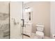 Modern bathroom showcasing a glass-enclosed shower, white vanity, and marble flooring at 21855 E Idyllwilde Dr, Parker, CO 80138