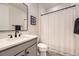 Bright bathroom featuring a modern vanity, sleek mirror, and a shower with a white curtain at 21855 E Idyllwilde Dr, Parker, CO 80138