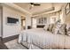 Comfortable primary bedroom featuring hardwood floors, neutral colors, and an ensuite bathroom at 21855 E Idyllwilde Dr, Parker, CO 80138