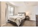 Comfortable bedroom with a queen-sized bed, soft carpeting, and lots of natural light from the large window at 21855 E Idyllwilde Dr, Parker, CO 80138