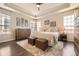 Spacious bedroom with tray ceilings, large windows, hardwood floors, and a walk-in closet at 21855 E Idyllwilde Dr, Parker, CO 80138