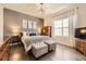 Stylish bedroom with a gray accent wall, modern lighting, hardwood floors, and a comfortable bed at 21855 E Idyllwilde Dr, Parker, CO 80138
