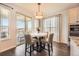Cozy dining area with modern lighting, a marble table, and access to an outdoor patio at 21855 E Idyllwilde Dr, Parker, CO 80138