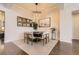 Elegant dining room featuring a modern chandelier, hardwood floors, and stylish decor at 21855 E Idyllwilde Dr, Parker, CO 80138
