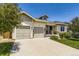 Inviting front exterior of a home with a well-kept lawn and two-car garage at 21855 E Idyllwilde Dr, Parker, CO 80138