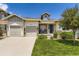 Charming single-Gathering home featuring a well-manicured lawn, stone accents, and a two-car garage at 21855 E Idyllwilde Dr, Parker, CO 80138